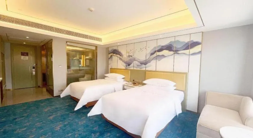 Bed in Venus Royal Hotel Guangxi Wuzhou Sanqicheng Meiguihu Park