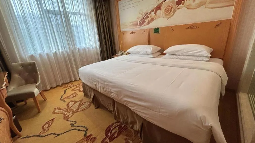 Bed in Vienna Hotel Guangxi Beiliu Passenger Station