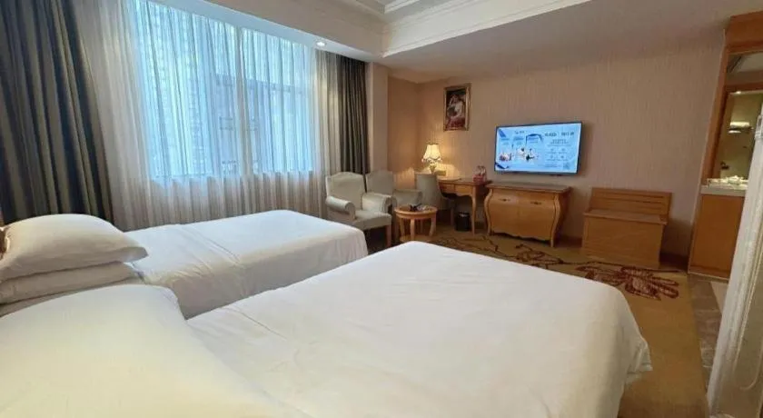 Bed in Vienna Hotel Guangxi Beiliu Passenger Station