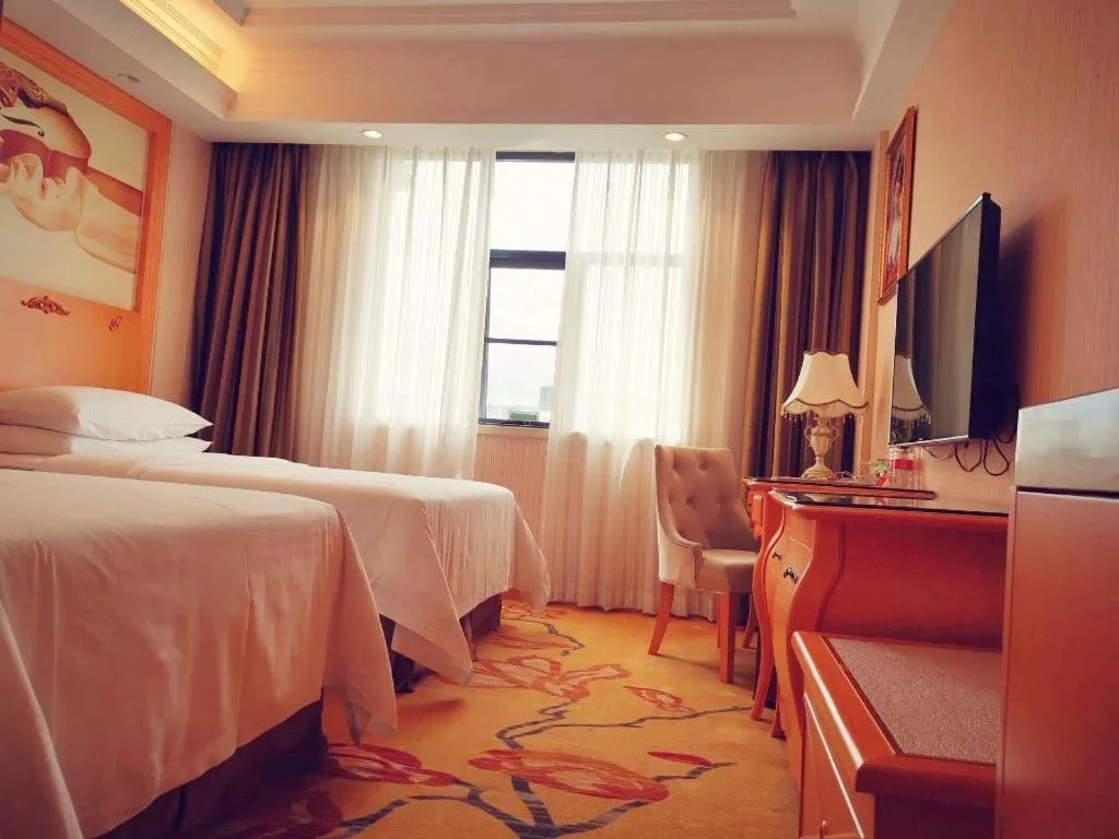 Bed in Vienna Hotel Guangxi Beiliu Passenger Station