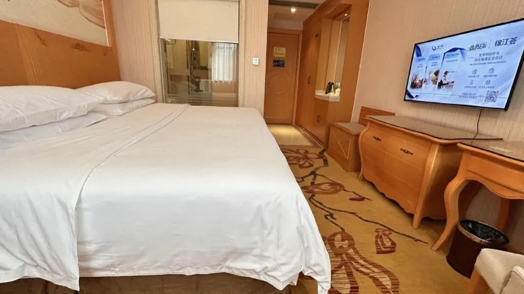 Bed in Vienna Hotel Guangxi Beiliu Passenger Station