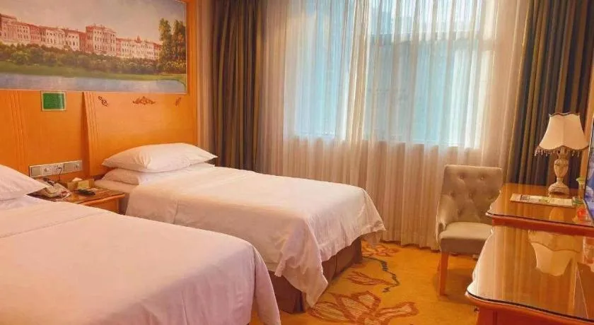 Bed in Vienna Hotel Guangxi Beiliu Passenger Station