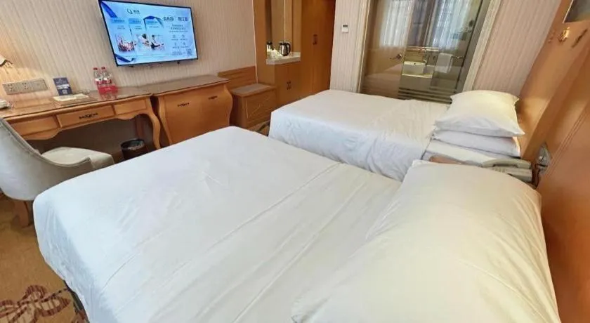Bed in Vienna Hotel Guangxi Beiliu Passenger Station