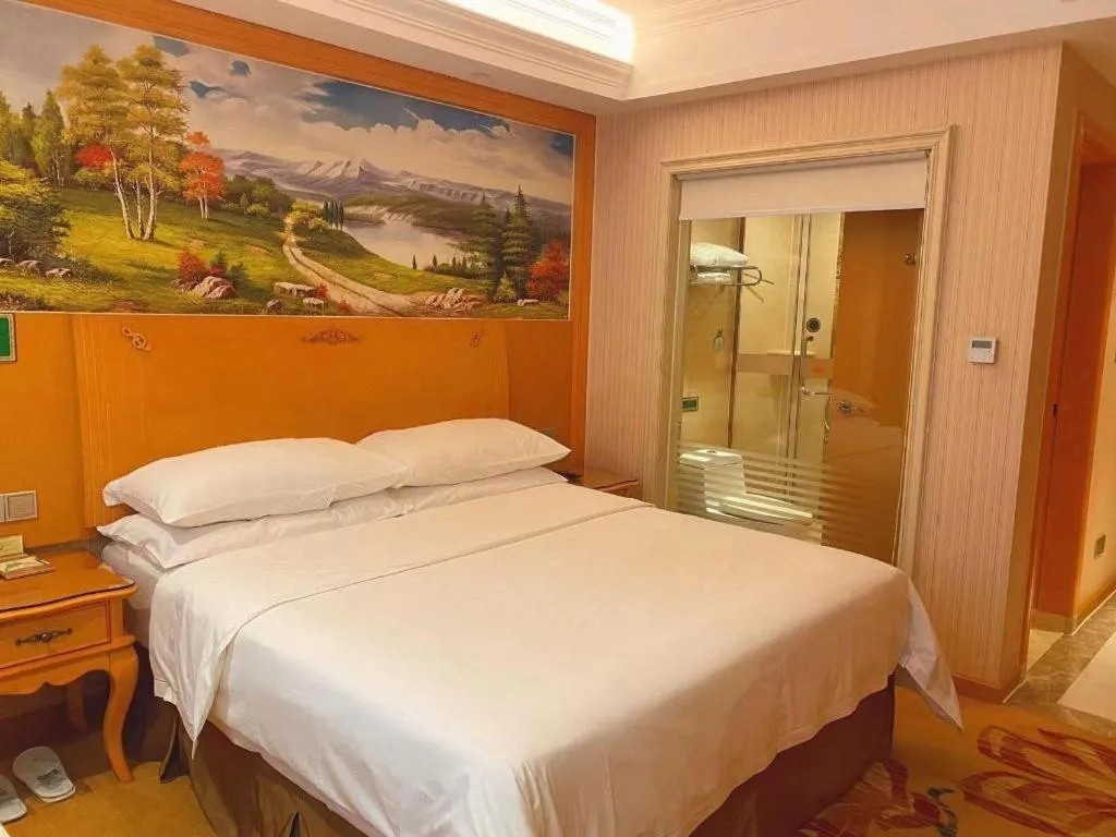 Bed in Vienna Hotel Guangxi Beiliu Passenger Station