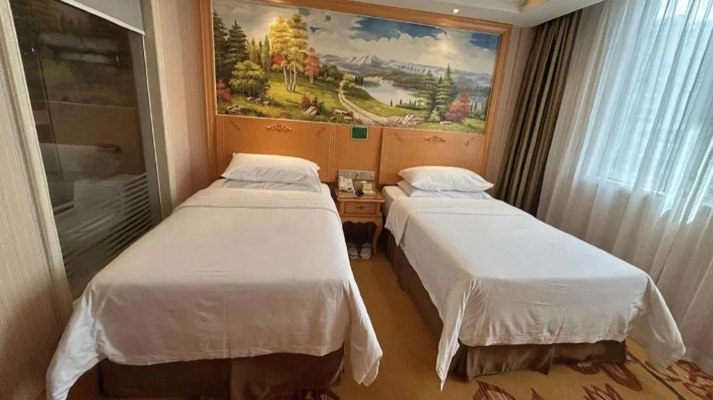 Bed in Vienna Hotel Guangxi Beiliu Passenger Station