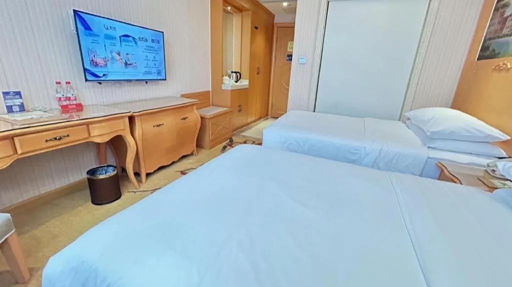 Bed in Vienna Hotel Guangxi Beiliu Passenger Station