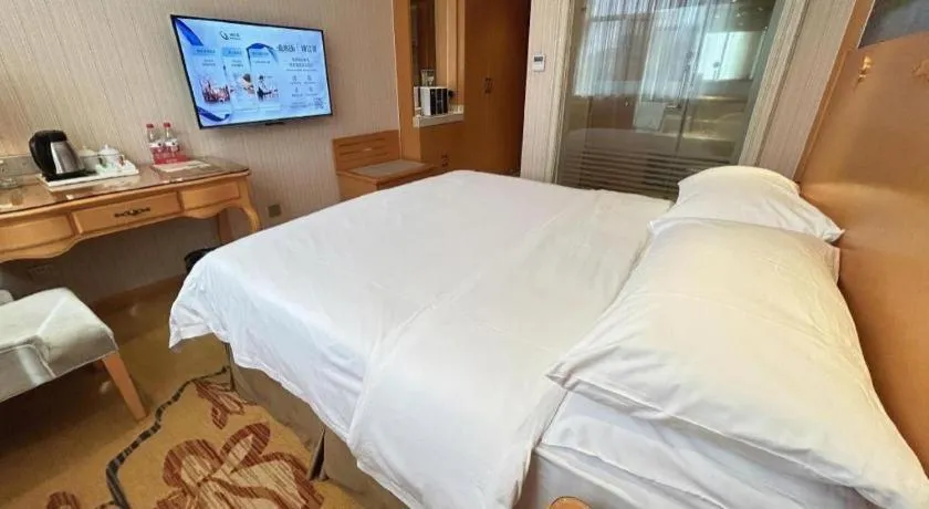 Bed in Vienna Hotel Guangxi Beiliu Passenger Station