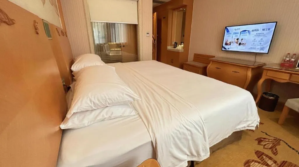 Bed in Vienna Hotel Guangxi Beiliu Passenger Station