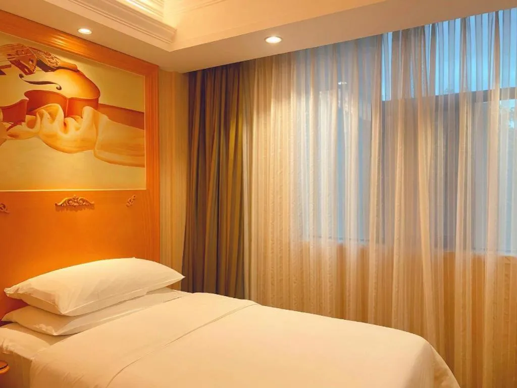 Bed in Vienna Hotel Guangxi Beiliu Passenger Station