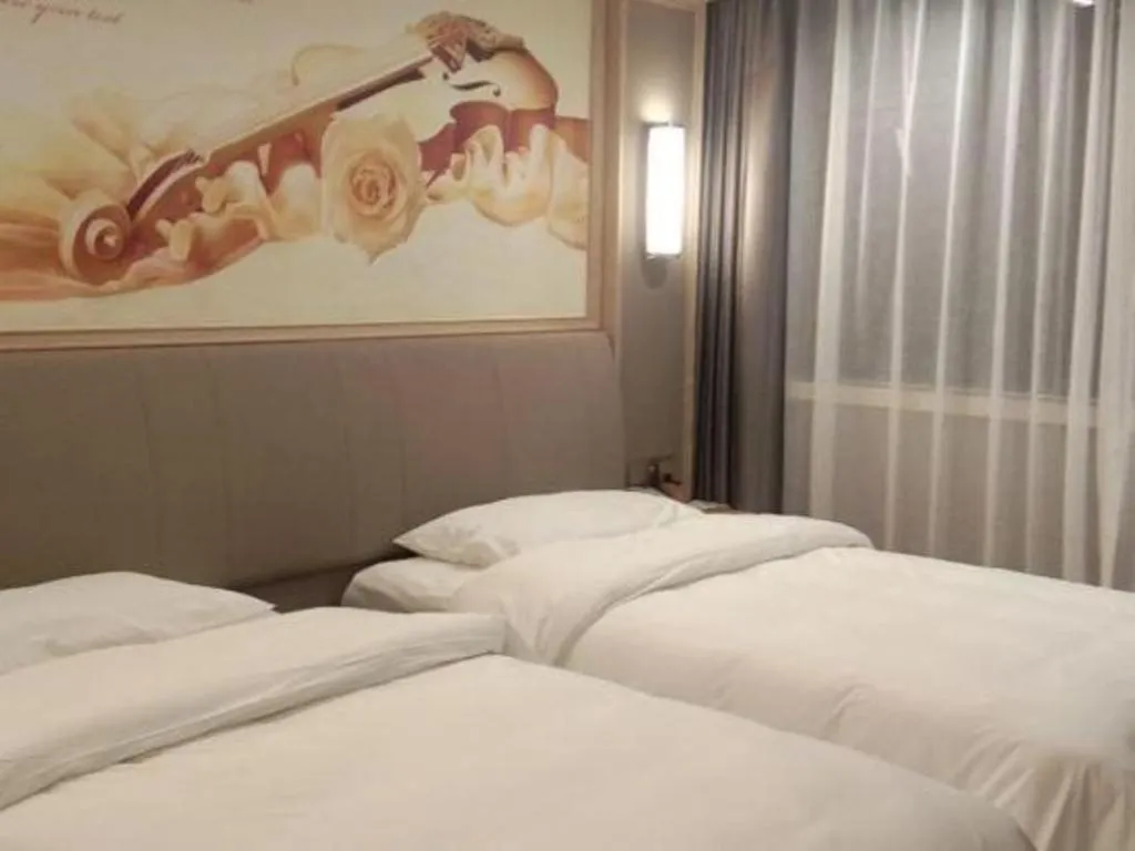Bed in Vienna Hotel Zhejiang Lishui Qingtian Post Building