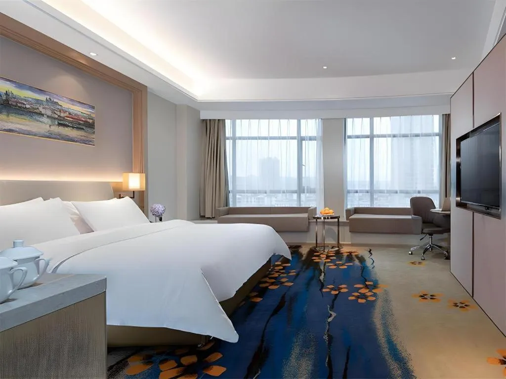 Bed in Vienna Hotel Xinfeng West High-Speed Railway Station