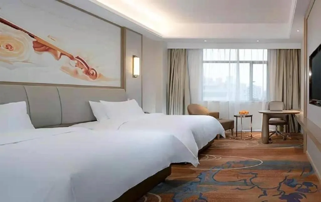 Bed in Vienna Hotel Xinfeng West High-Speed Railway Station