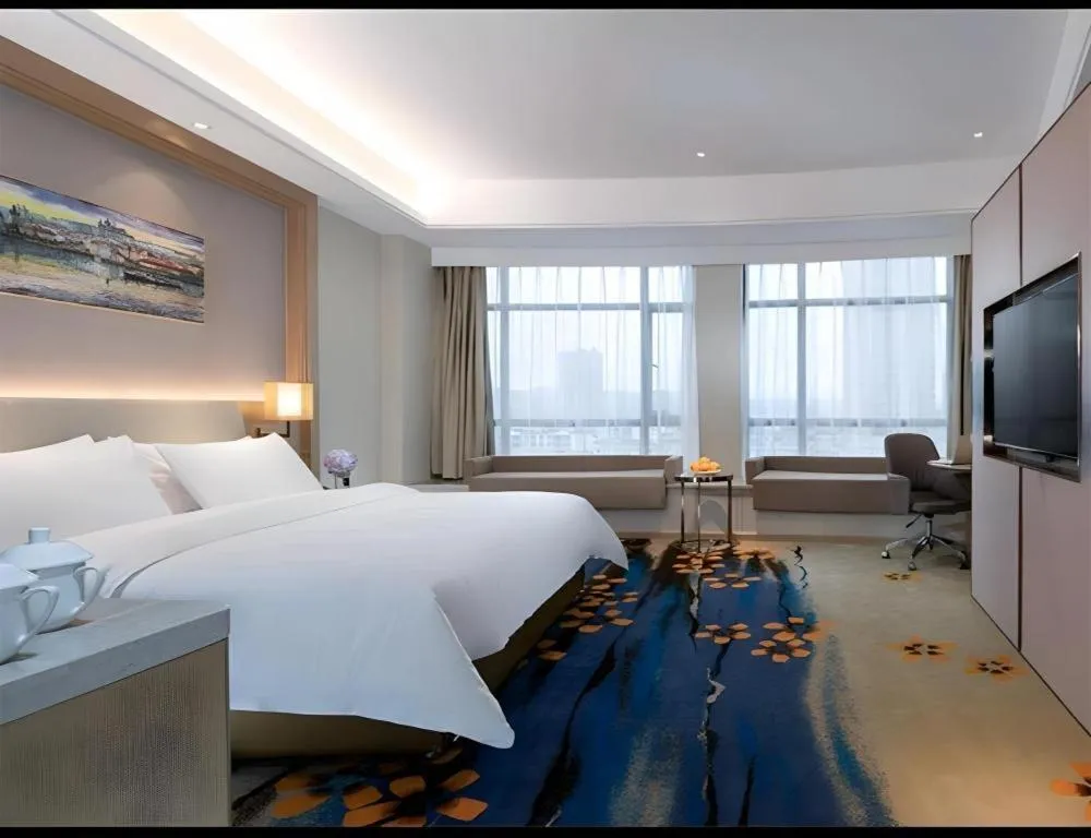 Bed in Vienna Hotel Xinfeng West High-Speed Railway Station