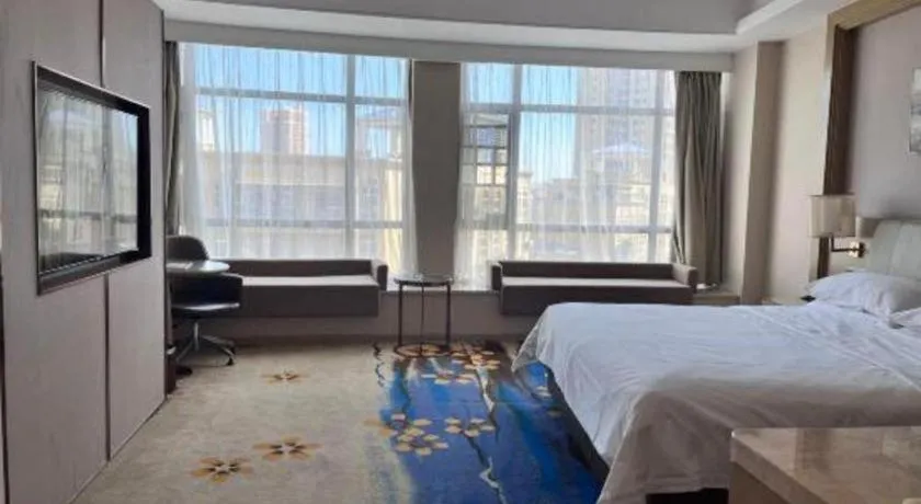 Bed in Vienna Hotel Xinfeng West High-Speed Railway Station