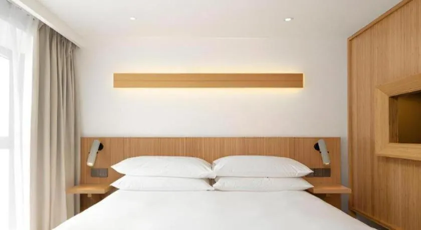 Bed in Meijin All Suites Hotel Suzhou