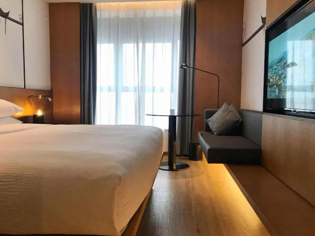 Bed in Meijin All Suites Hotel Suzhou