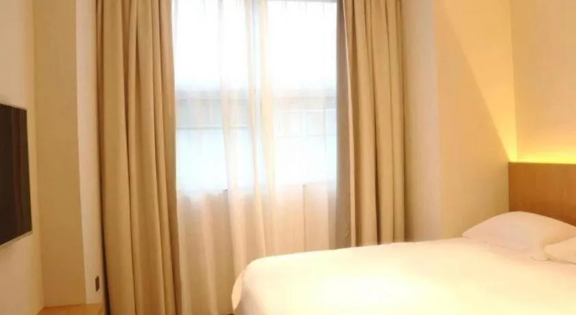 Bed in Meijin All Suites Hotel Suzhou