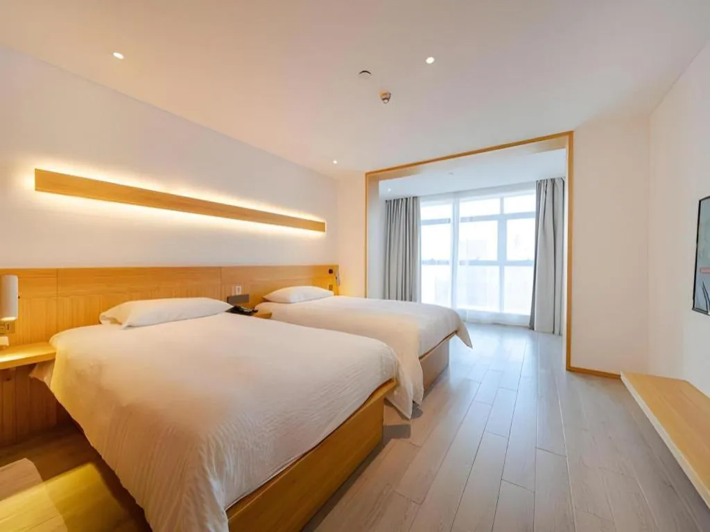 Bed in Meijin All Suites Hotel Suzhou