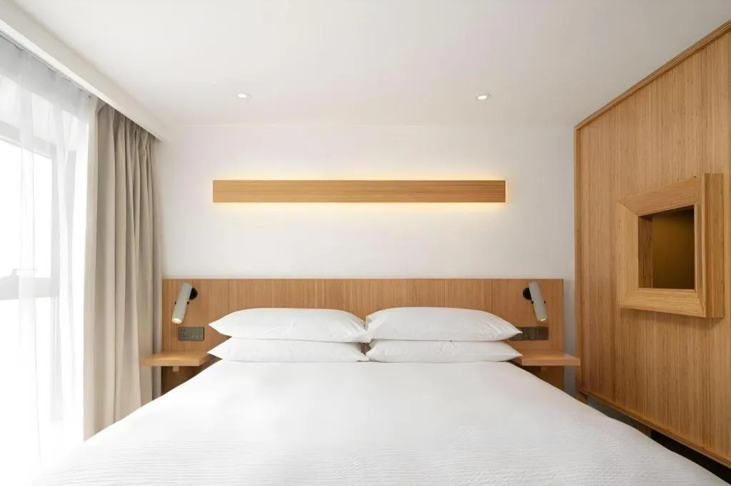 Bed in Meijin All Suites Hotel Suzhou