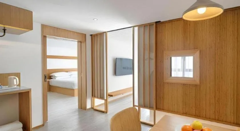 Bed in Meijin All Suites Hotel Suzhou