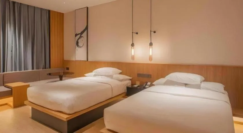 Bed in Meijin All Suites Hotel Suzhou