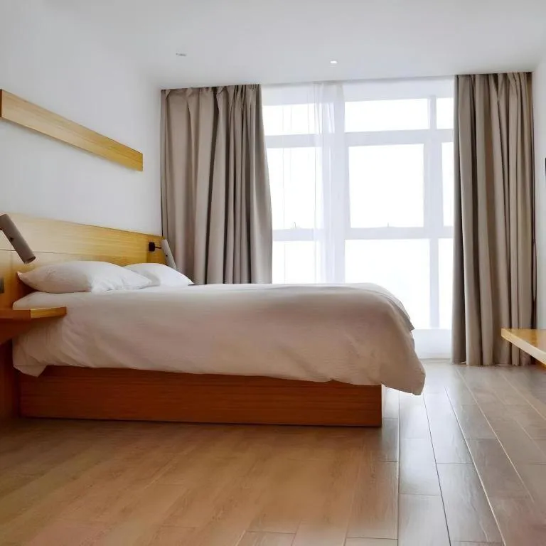 Bed in Meijin All Suites Hotel Suzhou