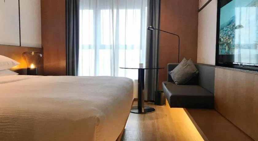 Bed in Meijin All Suites Hotel Suzhou