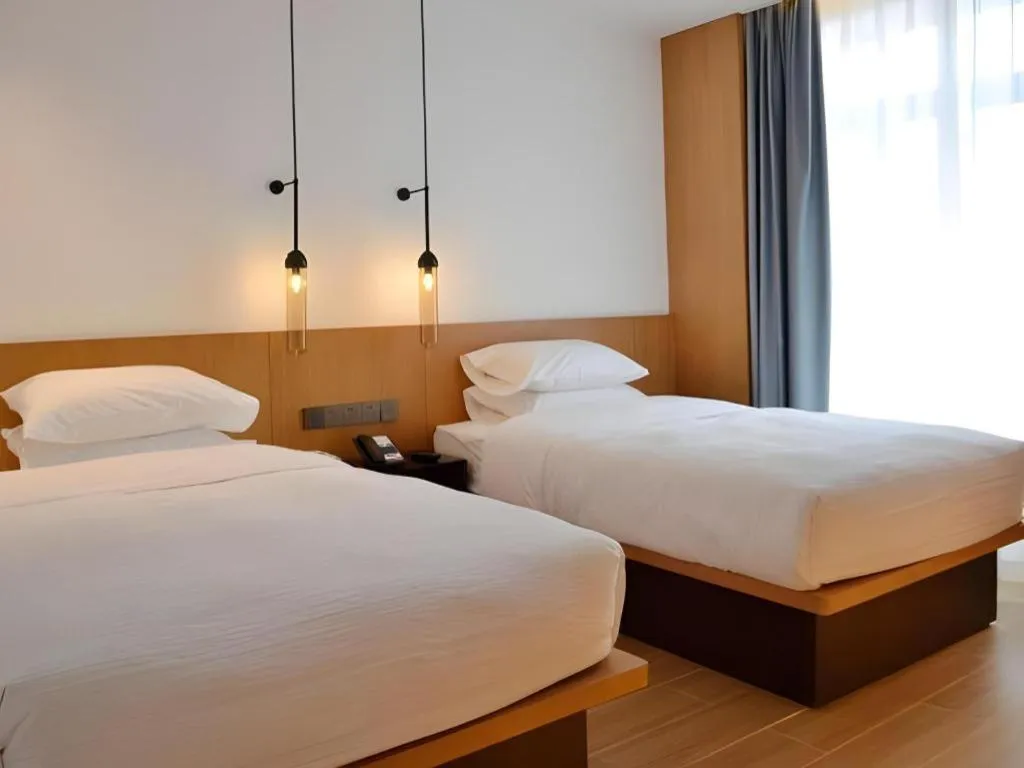 Bed in Meijin All Suites Hotel Suzhou