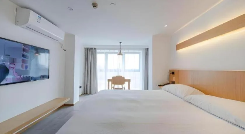 Bed in Meijin All Suites Hotel Suzhou