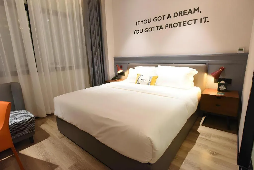 Bed in Premier City Comfort Hotel Hechi Luocheng Central Plaza