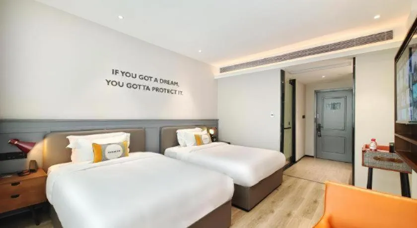 Bed in Premier City Comfort Hotel Hechi Luocheng Central Plaza