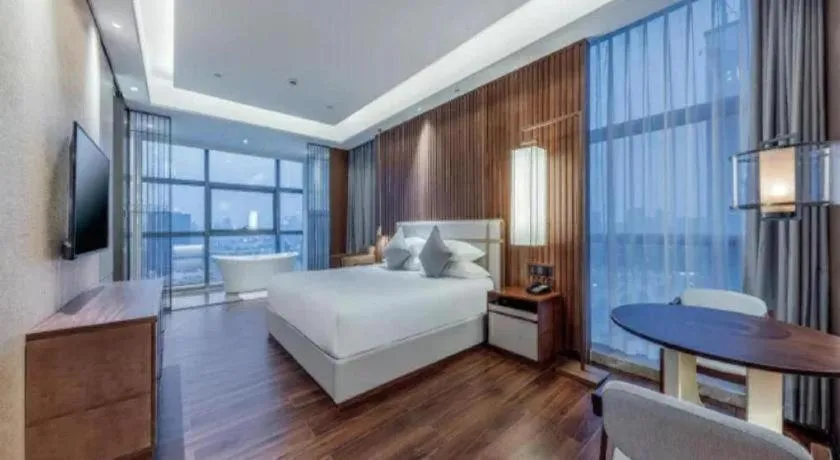 Bed in New Century Grand Hotel Ningbo Zhongdu