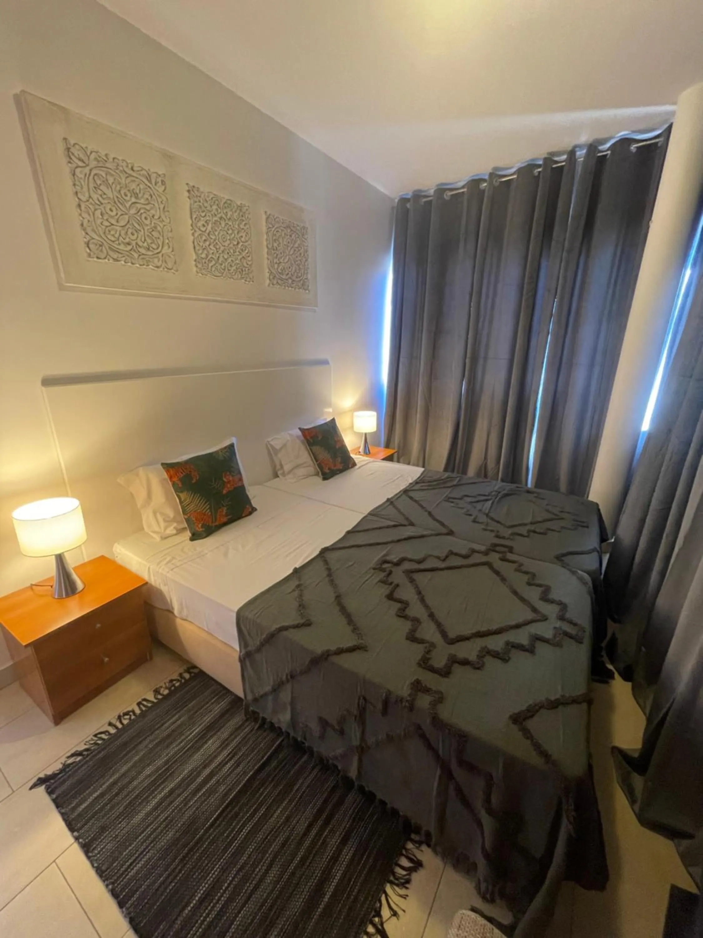 Bed in Esmeralda Holidays Apartments