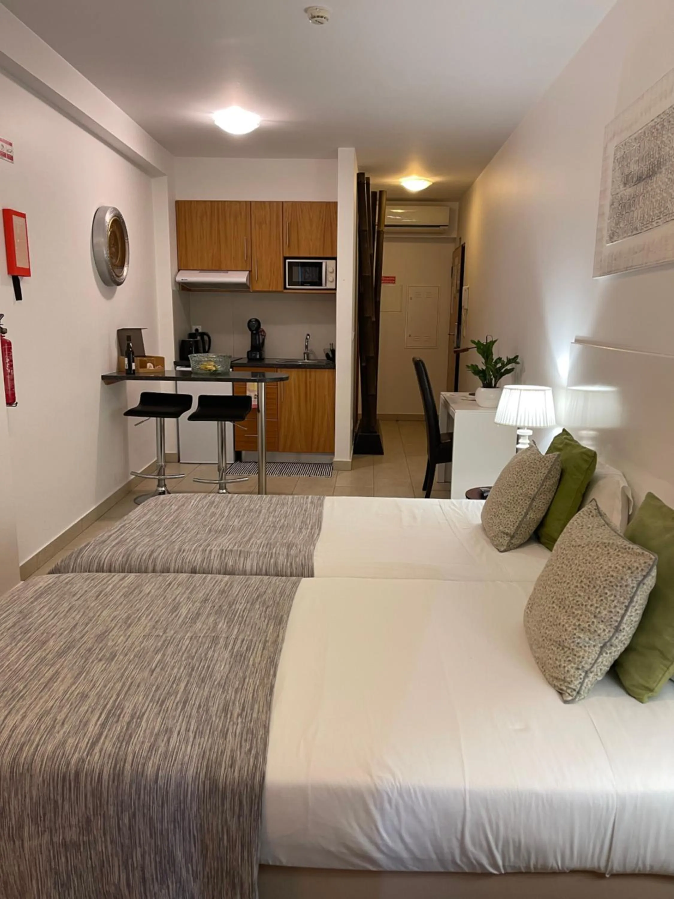 Bed in Esmeralda Holidays Apartments