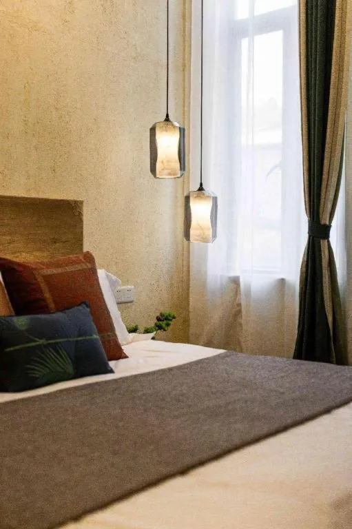 Bed in Origin Antique House and Hotel