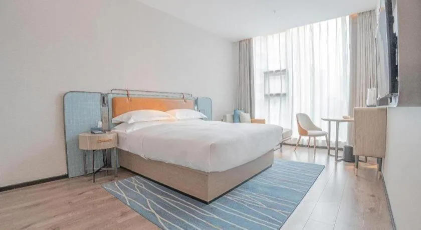 Bed in Echarm Hotel Zigong Machishui Wanda Plaza