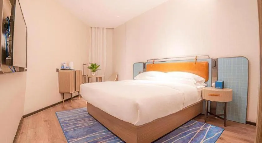 Bed in Echarm Hotel Zigong Machishui Wanda Plaza