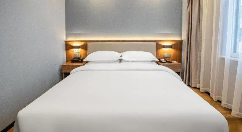 Bed in Borrman Hotel Zoucheng Huamaowan Mall