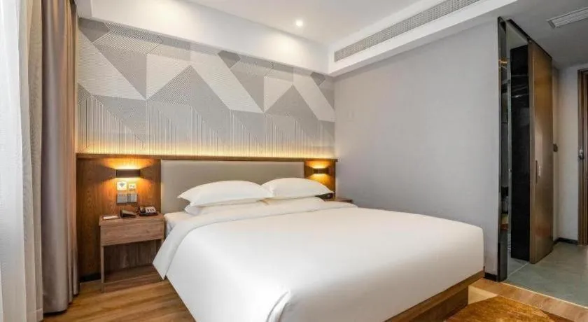 Bed in Borrman Hotel Zoucheng Huamaowan Mall