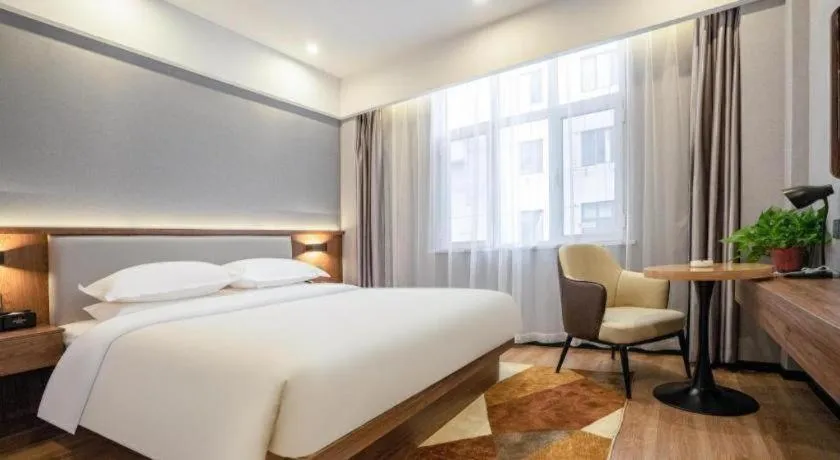 Bed in Borrman Hotel Zoucheng Huamaowan Mall