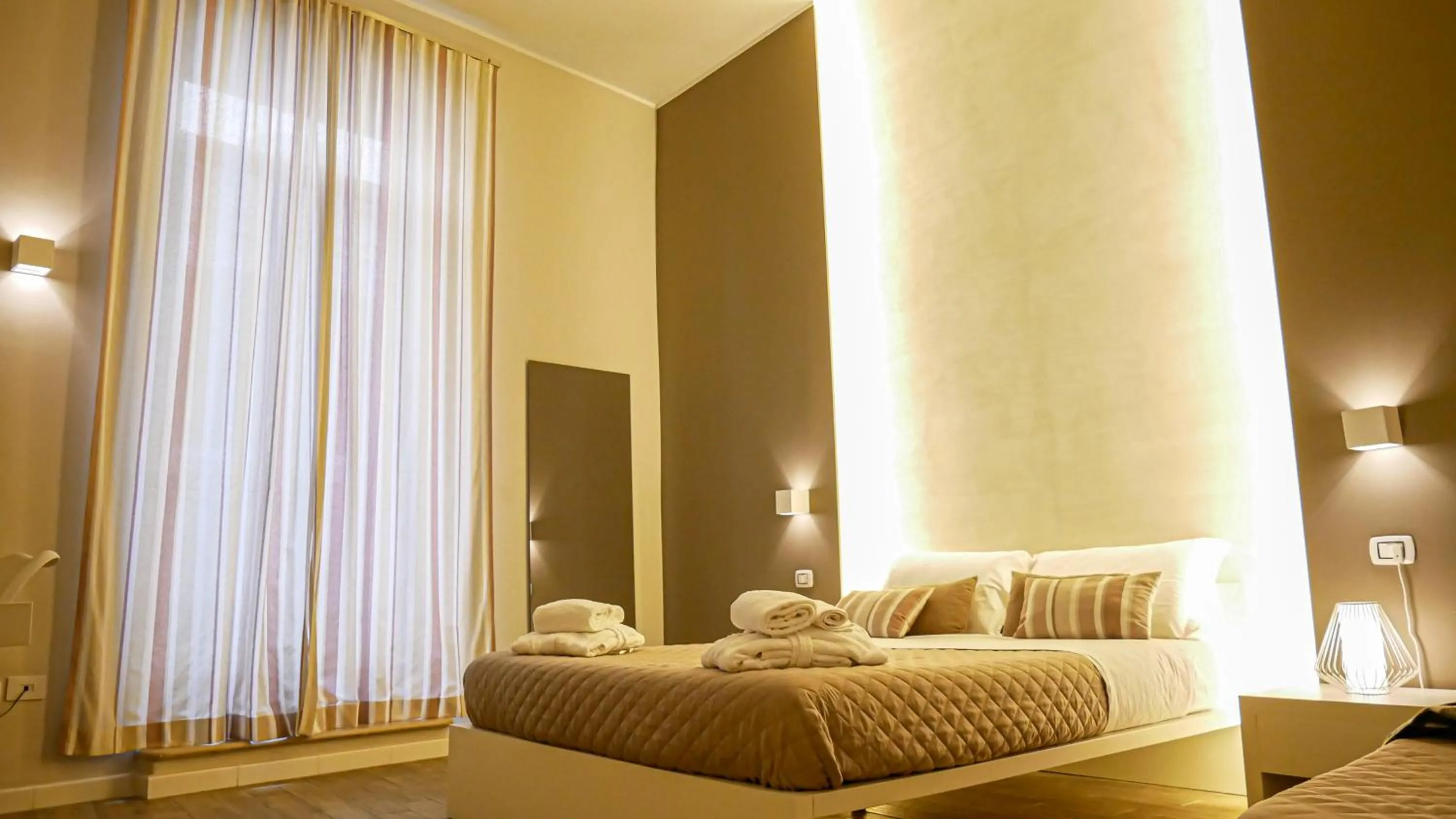 Bed in La Banchina Holiday Rooms