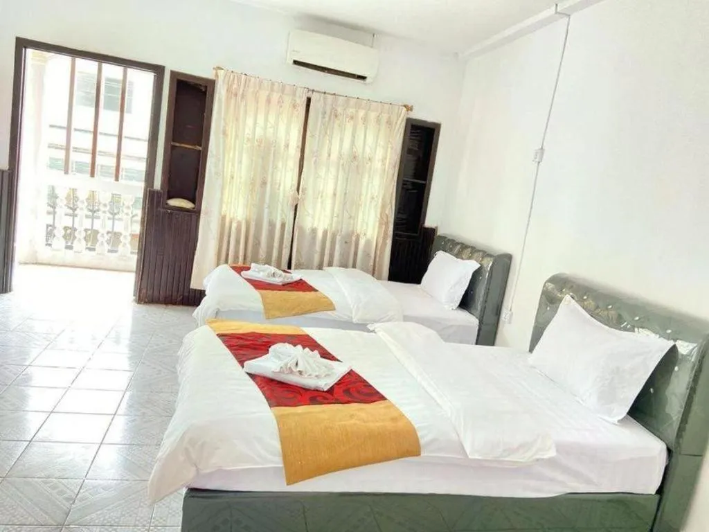 Bed in New Lao Paris Hotel