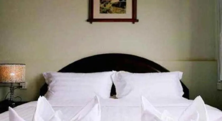 Bed in New Lao Paris Hotel