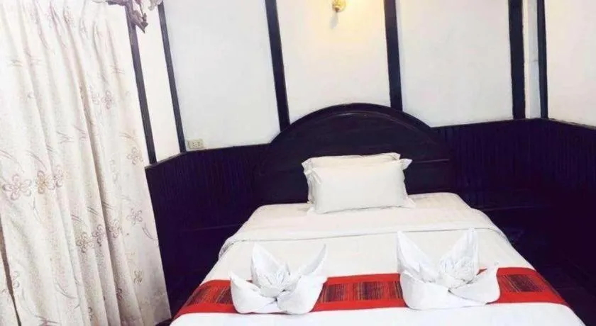 Bed in New Lao Paris Hotel