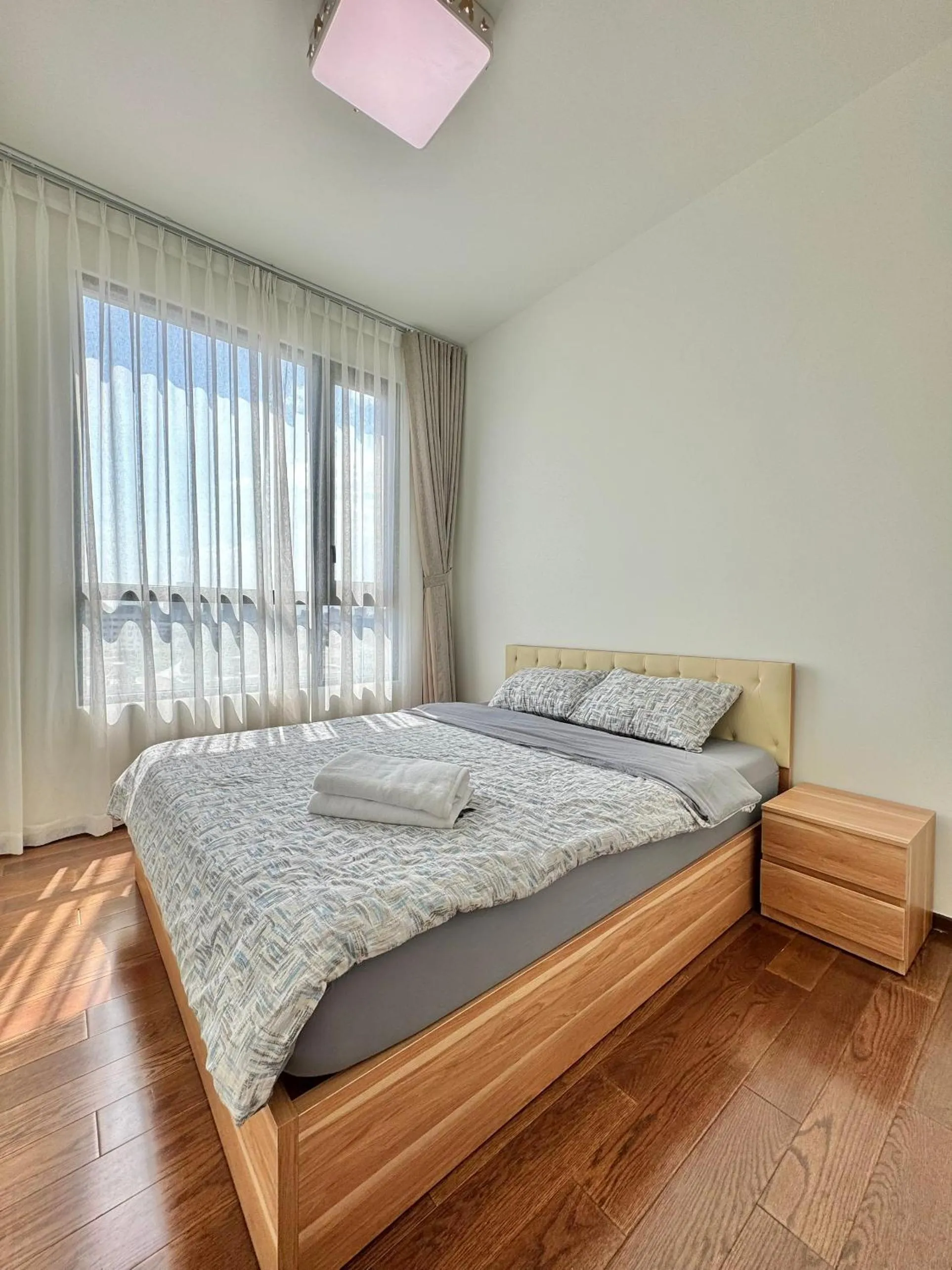 Bed in Homie's Dedge Thao Dien Luxury Apartment