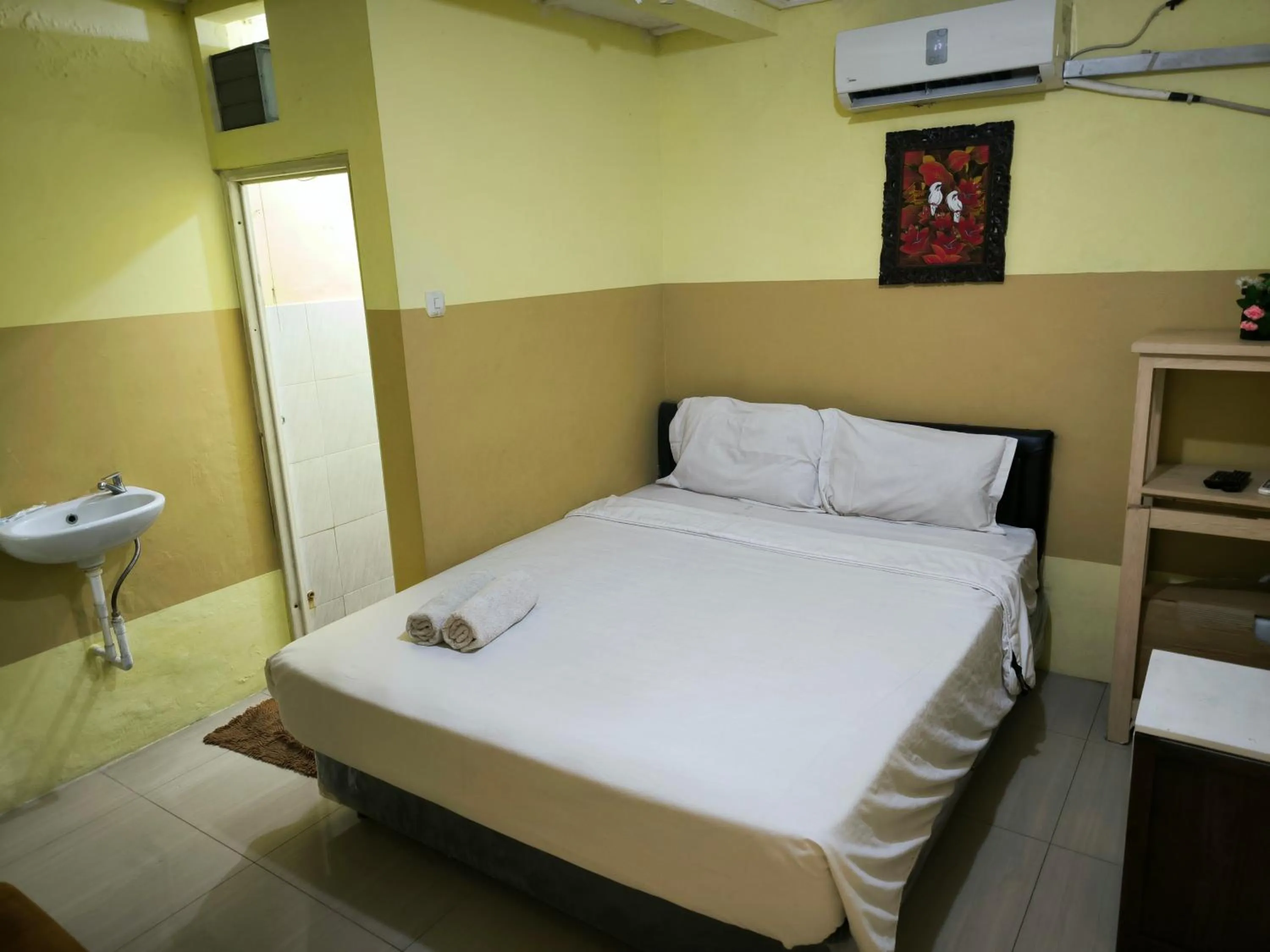 Bed in PROMOSIA GUEST HOUSE