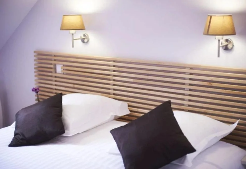 Bed in Logis Hôtel La ferme du Blanchot