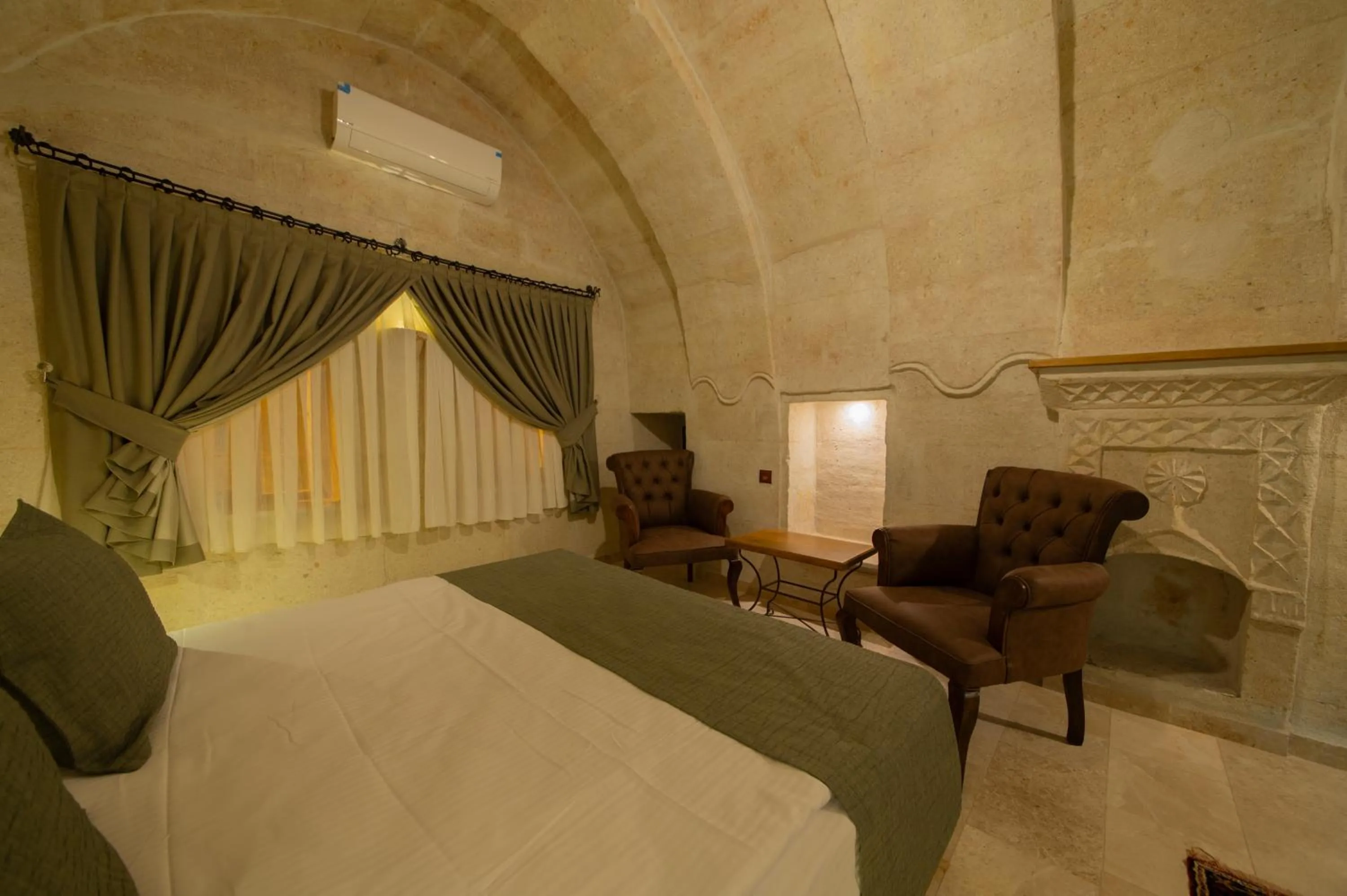 Bed in Ares Cave Suites