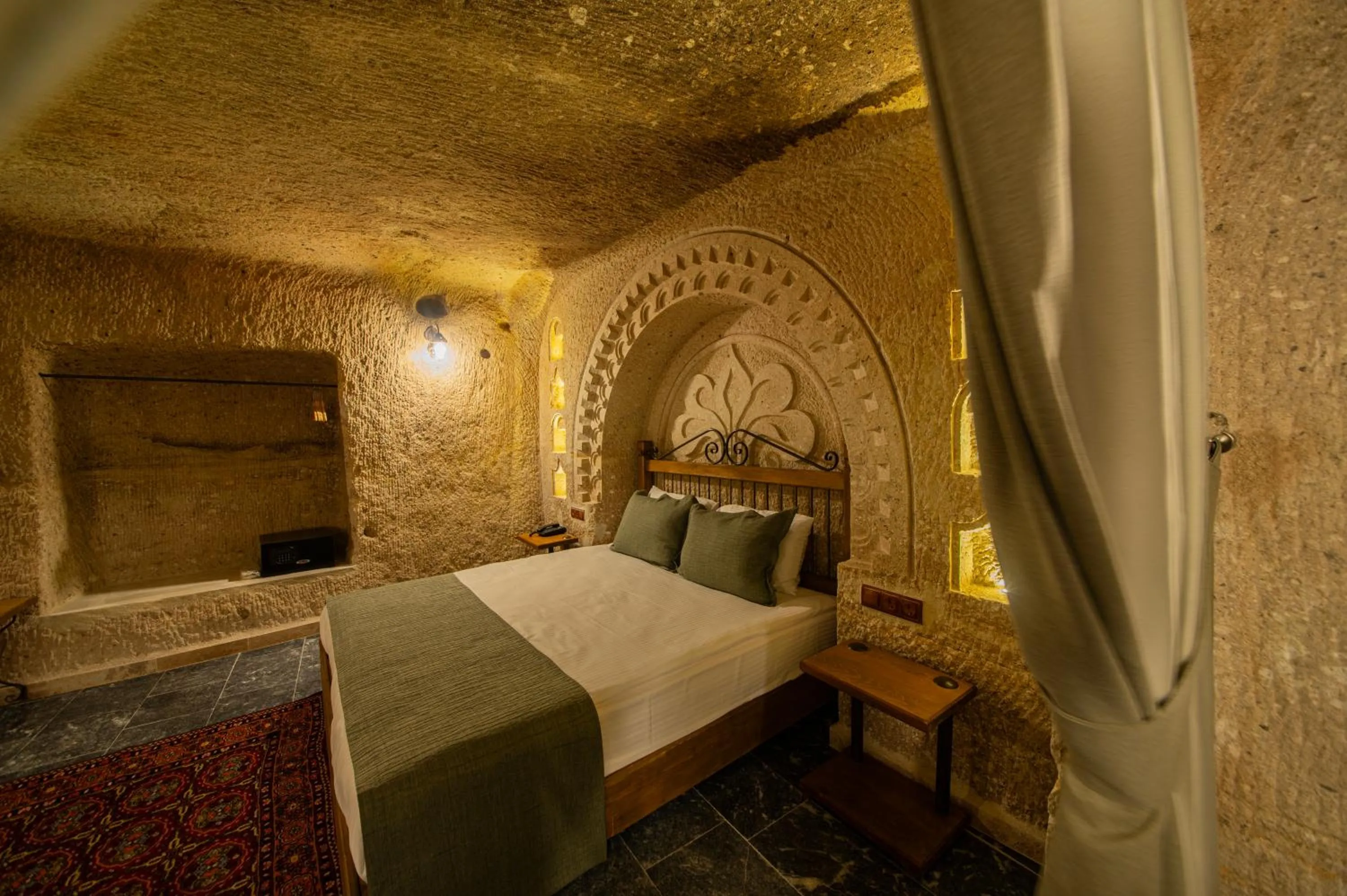 Bed in Ares Cave Suites