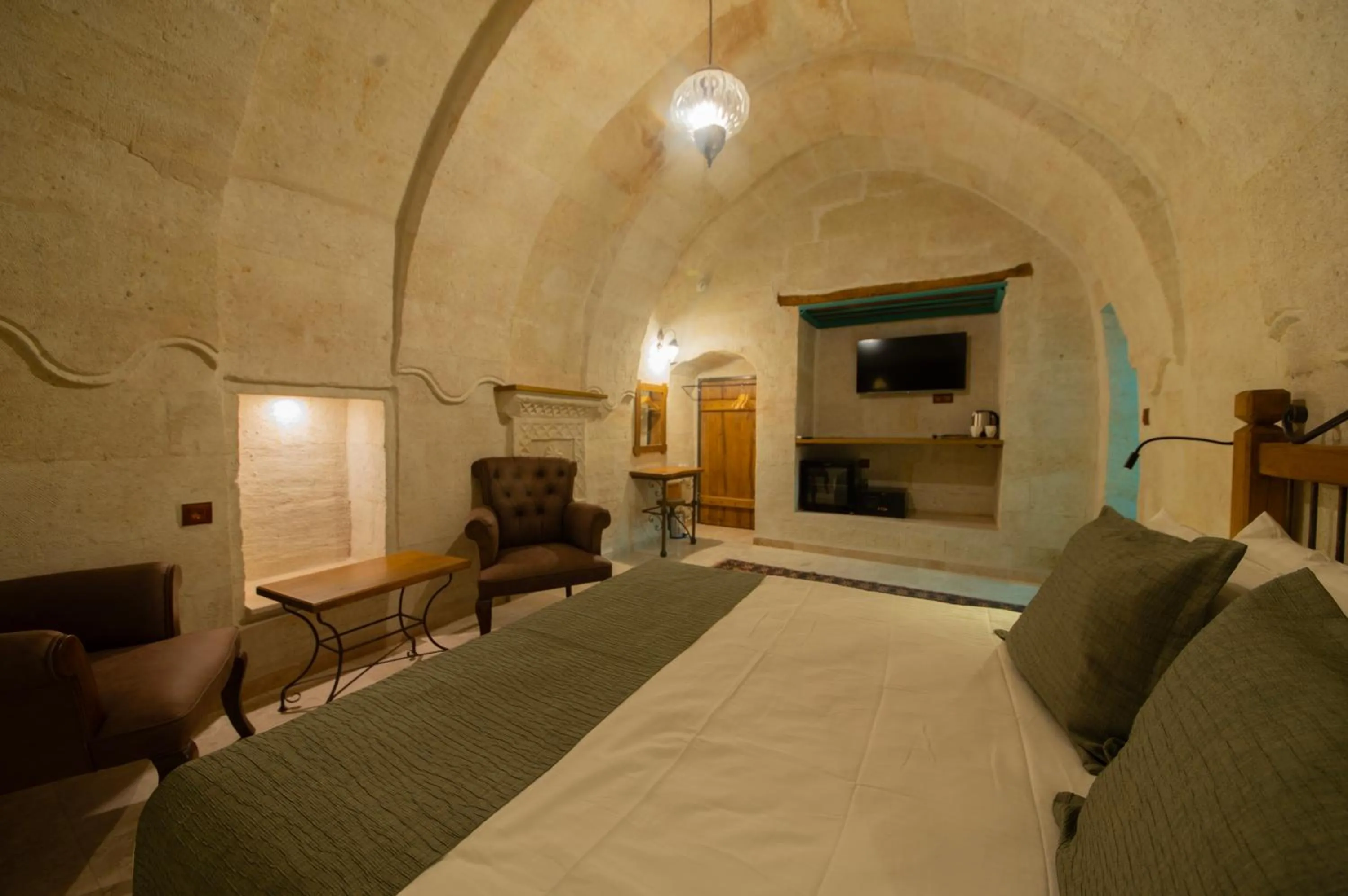Bed in Ares Cave Suites